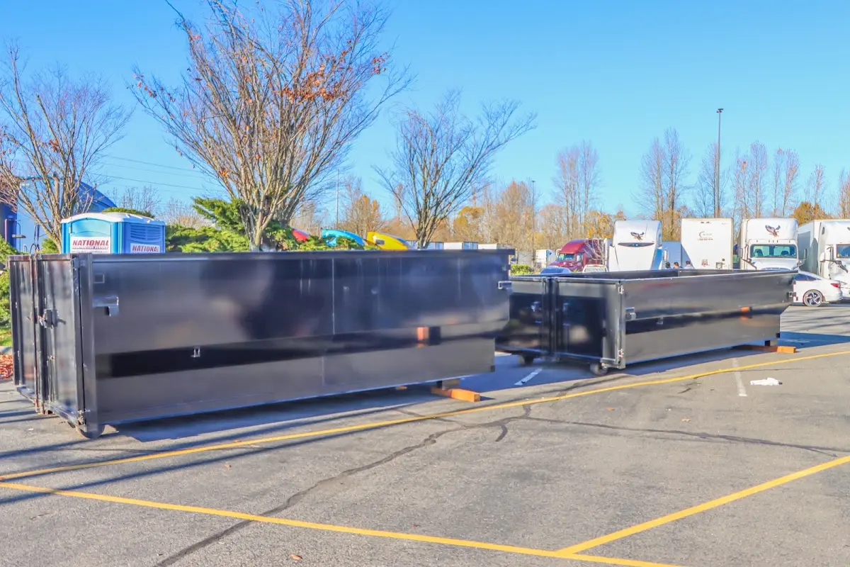 Professional dumpster rental service with roll-off container on residential driveway in Gunbarrel